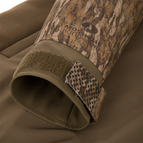 Close-up of the LST BMF Eqwader Full Zip with Primaloft's cuff, showcasing camo fabric, rubberized lining, and Velcro strap for adjustable weather protection.