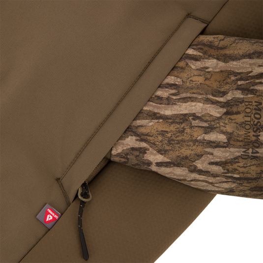 LST BMF Eqwader Full Zip with Primaloft jacket, showing olive-drab soft-shell fabric, Mossy Oak Bottomland camouflage lining, and PrimaLoft insulation tag, ideal for hunting.
