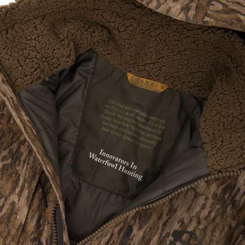 Inside view of Purewhitelaneshop's LST BMF Eqwader Full Zip with Primaloft, showcasing the sherpa collar and branded lining with story and slogan.