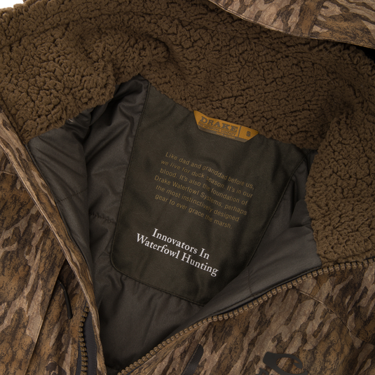 Inside view of Purewhitelaneshop's LST BMF Eqwader Full Zip with Primaloft, showcasing the sherpa collar and branded lining with story and slogan.