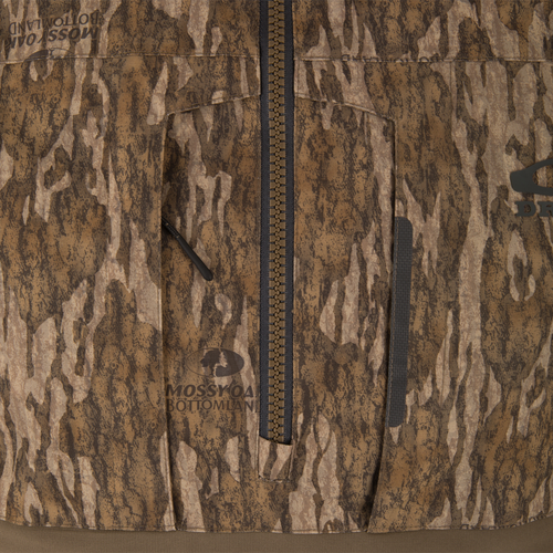 Close-up of LST BMF Eqwader Half Zip Jacket with Primaloft, featuring a central zipper, zippered chest pocket, and Mossy Oak Bottomland logo, ideal for hunting.