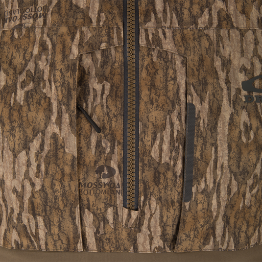 Close-up of LST BMF Eqwader Half Zip Jacket with Primaloft, featuring a central zipper, zippered chest pocket, and Mossy Oak Bottomland logo, ideal for hunting.