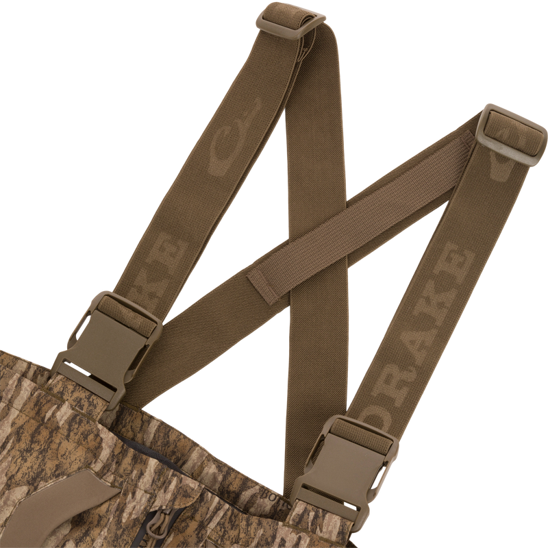 LST BMF Pit Bib with Primaloft features camo fabric, adjustable olive-brown suspenders with quick-release buckles, and a zippered fly for rugged outdoor performance.
