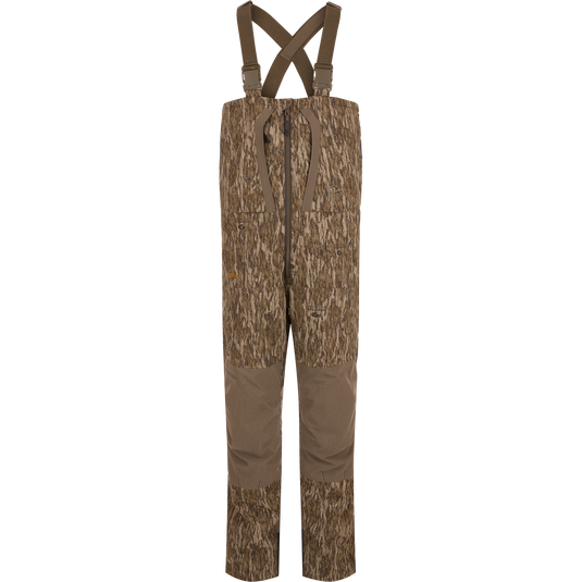 LST BMF Pit Bib with Primaloft: Camo-patterned hunting bib pants with reinforced brown fabric, adjustable suspenders, central front zipper, knee pads, and side zips for rugged performance.