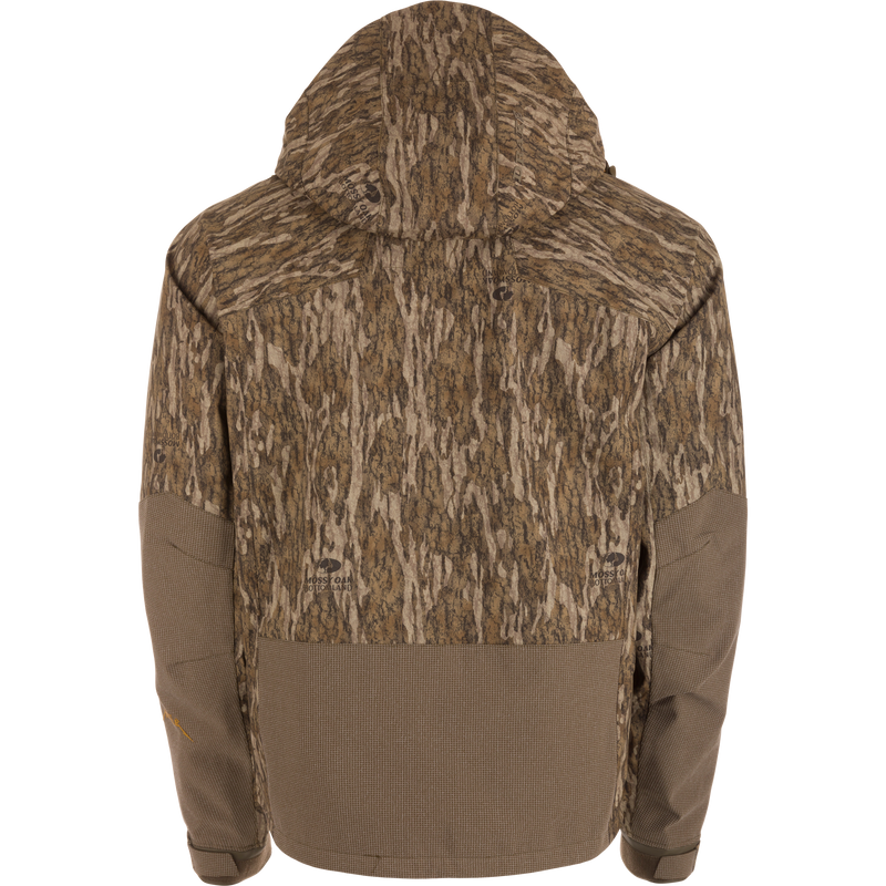 Back view of the LST BMF Pit Jacket with Mossy Oak Bottomland camo, solid brown accents, adjustable hood and cuffs, engineered for extreme weather conditions.