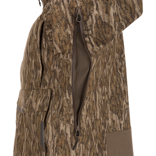 Close-up of the LST BMF Pit Jacket, highlighting its camouflage pattern, two-way zipper with mesh vent, and flap pocket for extreme hunting conditions.