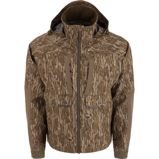 LST BMF Pit Jacket in woodland camo, featuring articulated elbows, adjustable hood, and multiple pockets, designed for extreme weather hunting with durable, weather-resistant materials.