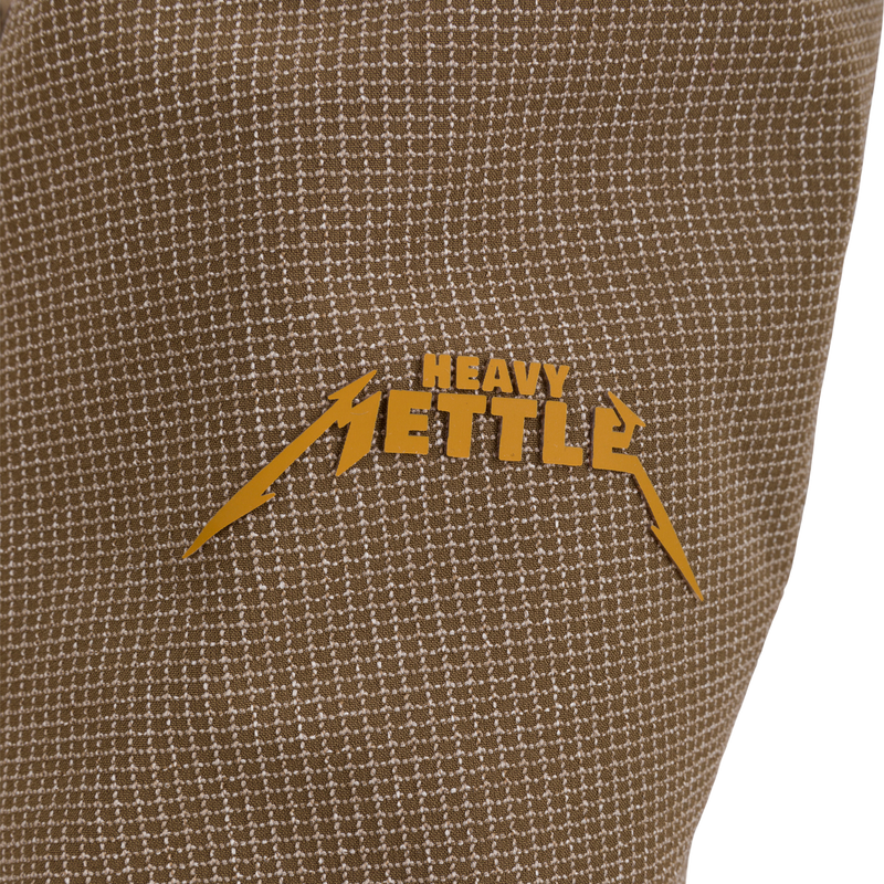Close-up of the LST BMF 3-in-1 Pit Jacket, showcasing a heavy-metal–style HEAVY METTLE logo on durable, textured woven fabric.