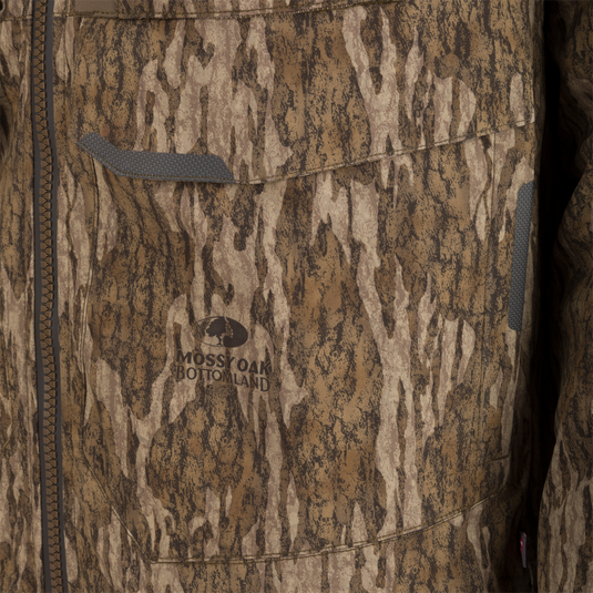 Close-up of the LST BMF 3-in-1 Pit Jacket with Primaloft, showcasing camouflage pattern, zippered front, flap pocket, and “Mossy Oak Bottomland” logo.
