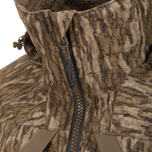 Close-up of LST BMF 3-in-1 Pit Jacket with Primaloft, showcasing camo pattern, high collar, heavy-duty zipper, and cord toggle for versatile outdoor protection.