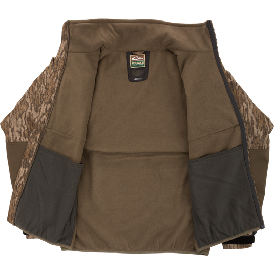 MST CommandXT Eqwader Full Zip Jacket, fleece-lined with camo panels, unzipped to show interior pockets and Drake label, ideal for rugged hunting conditions.