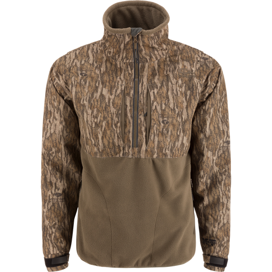 MST CommandXT Eqwader Half Zip Jacket with camo-patterned upper, olive fleece lower, zippered chest pockets, storm flap, and adjustable cuffs, ideal for rugged outdoor use.
