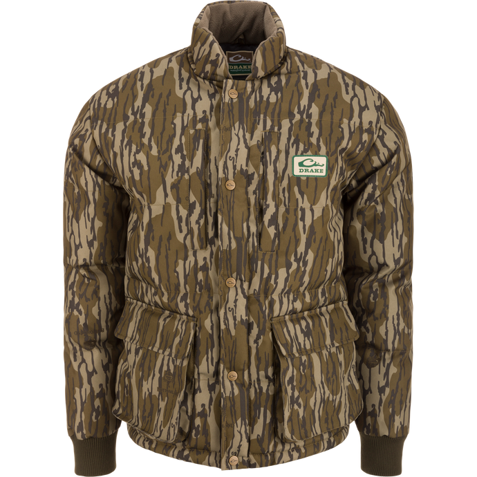 Throwback 80 Featherless Puffer Jacket with woodland camo, snap-button closure, ribbed cuffs, and large flap pockets, designed for outdoor enthusiasts and hunting.