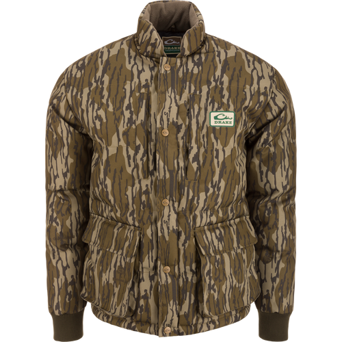 Throwback 80 Featherless Puffer Jacket with woodland camo, snap-button closure, ribbed cuffs, and large flap pockets, designed for outdoor enthusiasts and hunting.