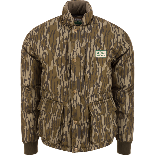 Throwback 80 Featherless Puffer Jacket with woodland camo, snap-button closure, ribbed cuffs, and large flap pockets, designed for outdoor enthusiasts and hunting.