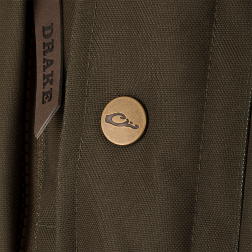 Close-up of the Throwback 80 Featherless Puffer Vest, highlighting its waterproof polyester material, fleece collar, and durable brass snaps.