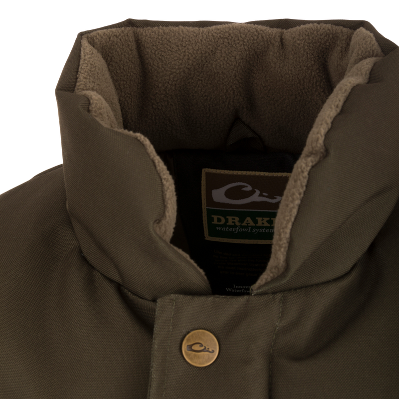 Close-up of the Throwback 80 Featherless Puffer Vest, highlighting its waterproof, windproof polyester fabric and large pockets, ideal for hunting and outdoor activities.