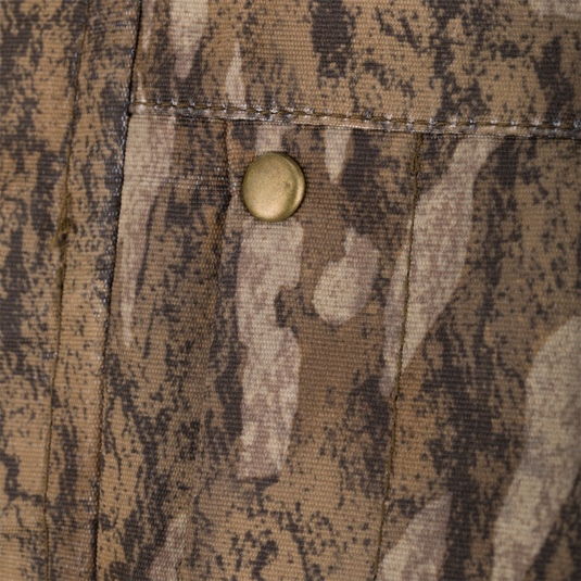 Close-up of a brass snap on camo fabric from the LST Hardline 3-in-1 Jacket, showcasing durable construction and functionality for versatile hunting conditions.
