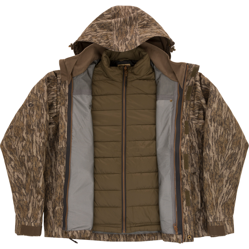 LST Hardline 3-in-1 Jacket featuring a tree-bark camo shell with hood and an olive-green quilted liner, designed for adaptable, high-quality hunting protection.