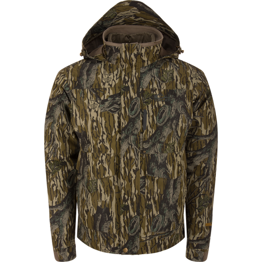 LST Hardline 3-in-1 Jacket in tree-bark camouflage, featuring a hood, high collar, zip-and-snap front, multiple pockets, and adjustable cuffs for versatile hunting protection.