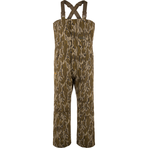 LST Hardline Insulated Bib: Camouflage-pattern, waterproof chest-high waders with adjustable straps, handwarmer pockets, and articulated knees for enhanced mobility in harsh hunting or fishing conditions.