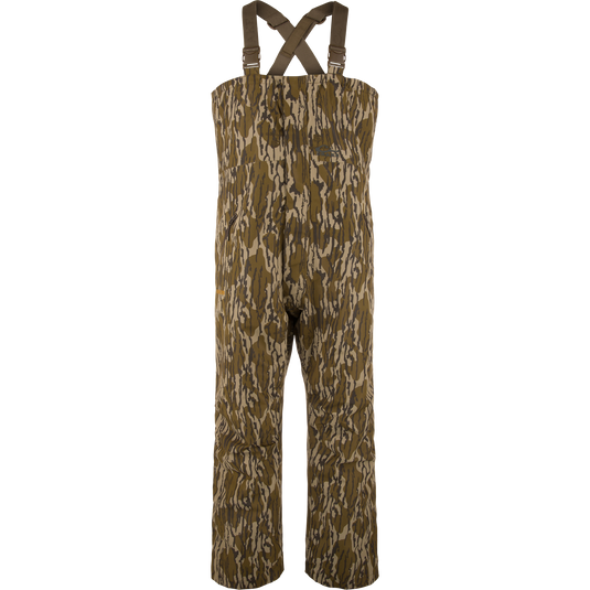 LST Hardline Insulated Bib: Camouflage-pattern, waterproof chest-high waders with adjustable straps, handwarmer pockets, and articulated knees for enhanced mobility in harsh hunting or fishing conditions.