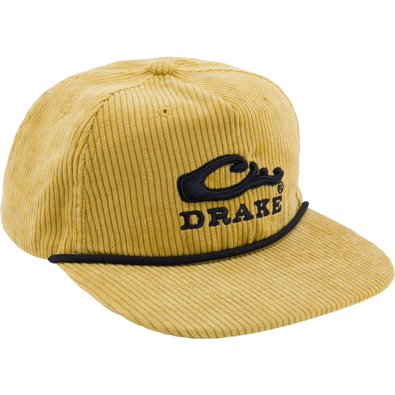Mustard-yellow corduroy cap with Drake logo, black piping, paracord rope detail on mid-crown, offering rugged style and comfort.