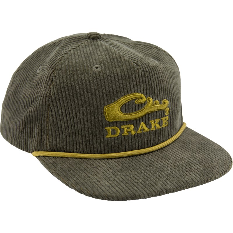 Drake X Lost Hat Goat Rope Corduroy Cap features an olive-green five-panel design, mustard-yellow Drake logo, and rugged paracord detail, offering stylish, versatile outdoor flair.
