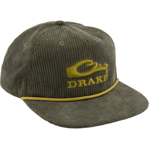 Drake X Lost Hat Goat Rope Corduroy Cap features an olive-green five-panel design, mustard-yellow Drake logo, and rugged paracord detail, offering stylish, versatile outdoor flair.