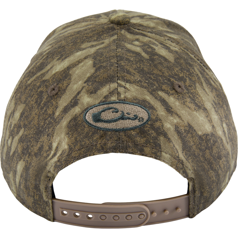 Back view of the Side Logo Cap, featuring a camouflage pattern, oval logo, and adjustable tan snap-strap closure, highlighting Purewhitelaneshop's quality craftsmanship.
