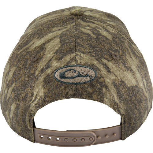 Back view of the Side Logo Cap, featuring a camouflage pattern, oval logo, and adjustable tan snap-strap closure, highlighting Purewhitelaneshop's quality craftsmanship.