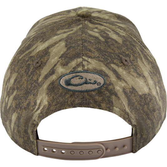 Back view of the Side Logo Cap, featuring a camouflage pattern, oval logo, and adjustable tan snap-strap closure, highlighting Purewhitelaneshop's quality craftsmanship.