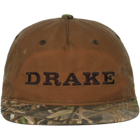 Waxed Flatbill Ball Cap with DRAKE embroidery, featuring a brown canvas crown and camouflage brim, offering a stylish, unstructured fit for outdoor enthusiasts.