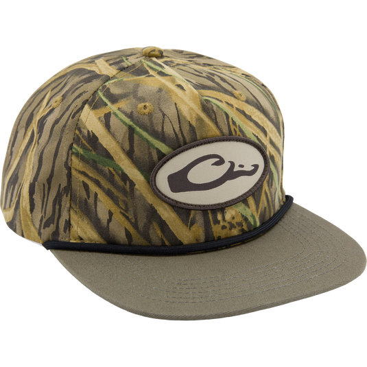 Drake X Lost Hat Hybrid Goat Rope Cap features a camo pattern, oval C patch, cord detail, and adjustable snap-back for a stylish and durable fit.