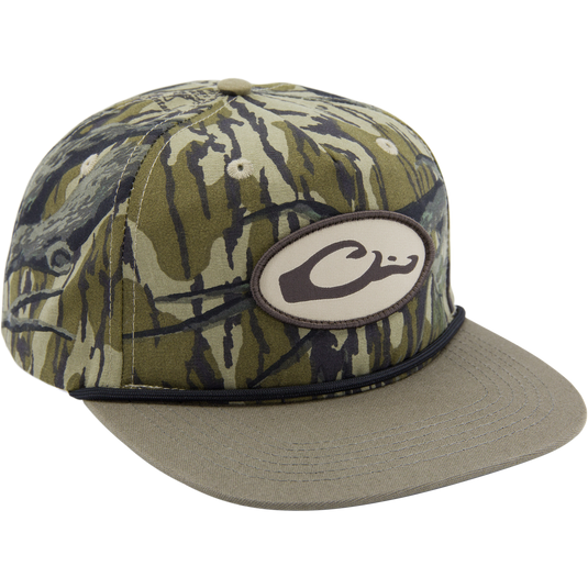 Drake X Lost Hat Hybrid Goat Rope Cap featuring woodland-camo pattern, oval C logo patch, olive brim, and snap-back closure for adjustable fit.