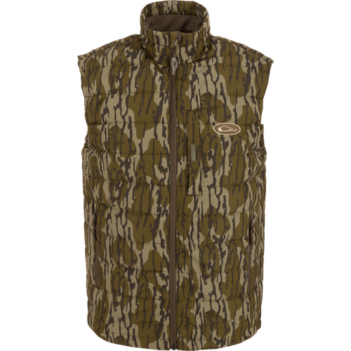 MST Synthetic Down Pack Vest featuring a camouflage design, horizontal baffle, zipper closure, and adjustable drawcord waist, suitable for layering in hunting or outdoor activities.