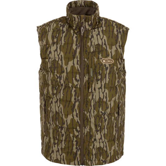 MST Synthetic Down Pack Vest featuring a camouflage design, horizontal baffle, zipper closure, and adjustable drawcord waist, suitable for layering in hunting or outdoor activities.