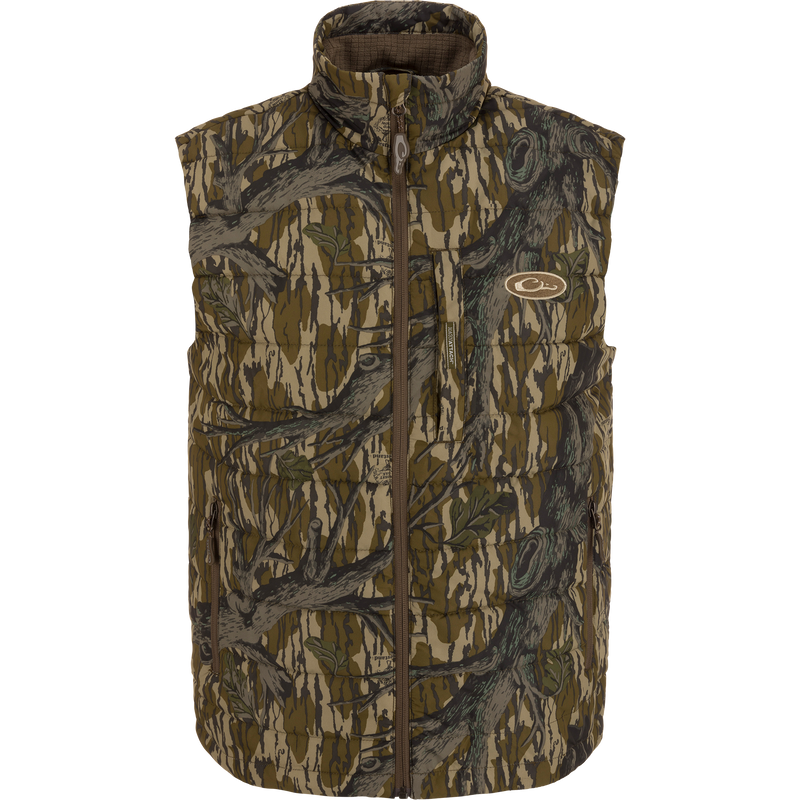 MST Synthetic Down Pack Vest featuring a camouflage pattern and logo, designed for warmth and packability, ideal for hunting with abrasion-resistant, matte-finish shell.