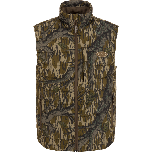 MST Synthetic Down Pack Vest featuring a camouflage pattern and logo, designed for warmth and packability, ideal for hunting with abrasion-resistant, matte-finish shell.
