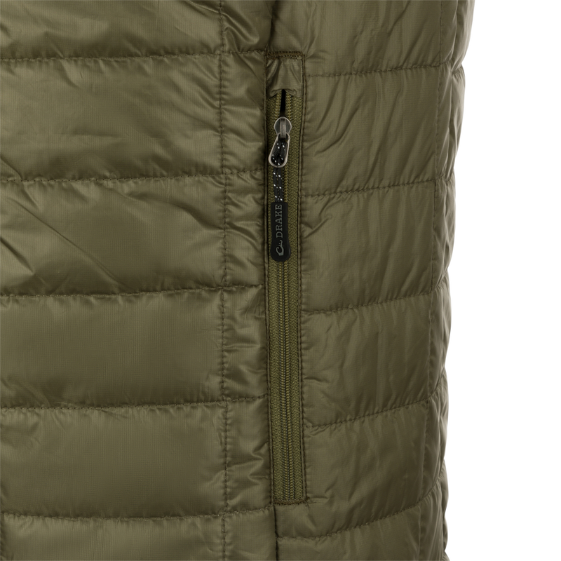 A close-up of the Synthetic Down Pac-Vest jacket's zipper, made of 100% polyester shell with a DWR water-repellent finish.