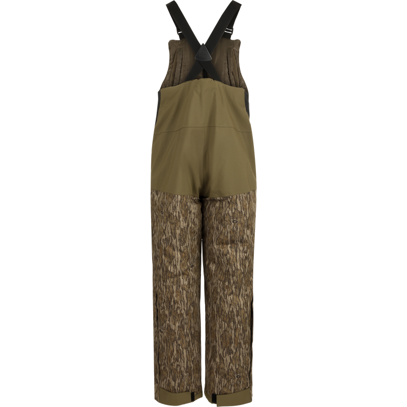 LST Reflex Insulated Bib: Brown overalls with tree pattern, knee-length zippers, reinforced knees and seat, fleece-lined hand warmer pockets.