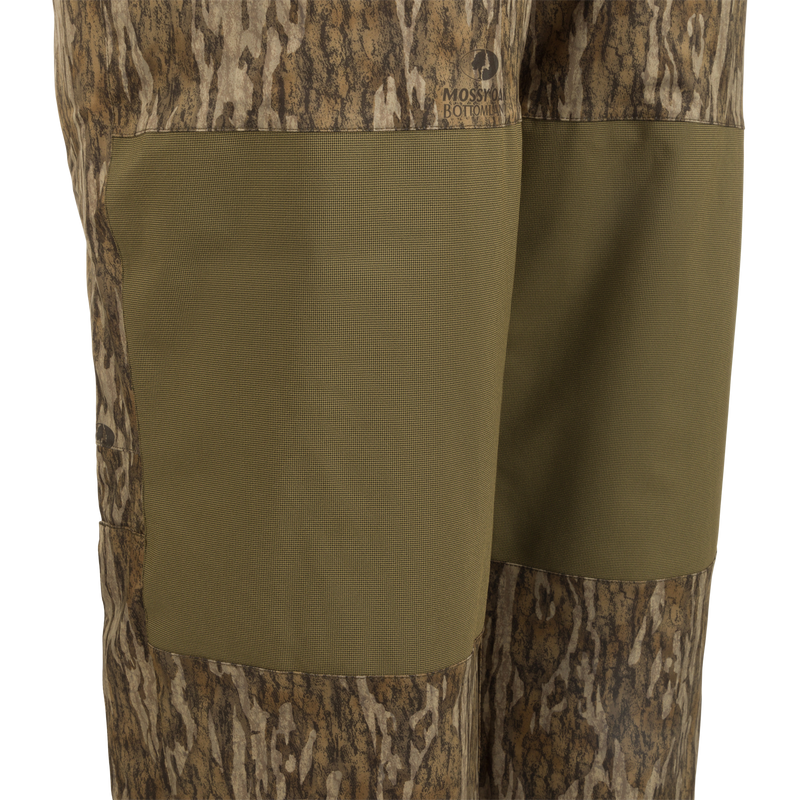 A pair of Reflex™ Insulated Bibs made of waterproof, windproof, and breathable fabric. Features include adjustable suspenders, reinforced knees and seat, and knee-length side leg zippers.