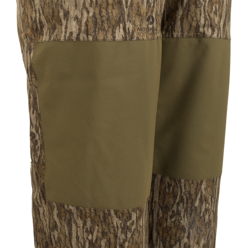 A pair of Reflex™ Insulated Bibs made of waterproof, windproof, and breathable fabric. Features include adjustable suspenders, reinforced knees and seat, and knee-length side leg zippers.