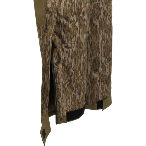 A close-up of the LST Reflex Insulated Bib, featuring knee-length zippers and reinforced knees for rugged durability and performance.