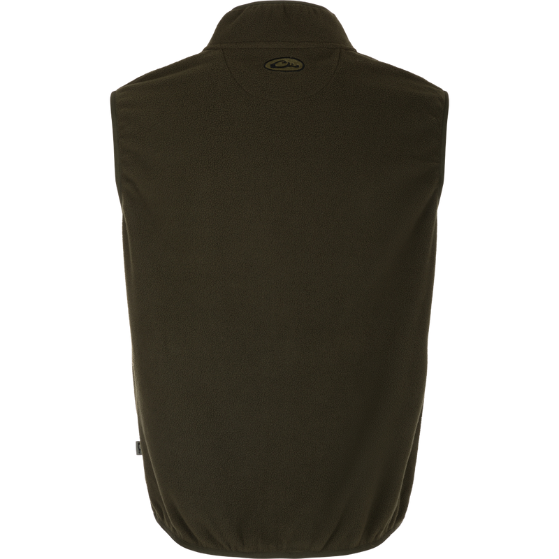 A close-up of the Camp Fleece Vest, a lightweight and breathable layering piece for Spring or Fall outfits. Made of 100% polyester micro-fleece with moisture-wicking properties. Features include anti-pill treatment, vertical Magnattach™ pocket, and lower zippered hand warmer pockets. Perfect for camping or pairing with Drake outerwear.