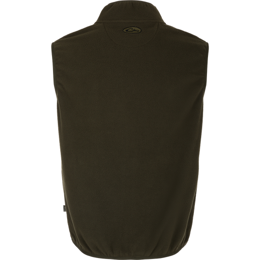 A close-up of the Camp Fleece Vest, a lightweight and breathable layering piece for Spring or Fall outfits. Made of 100% polyester micro-fleece with moisture-wicking properties. Features include anti-pill treatment, vertical Magnattach™ pocket, and lower zippered hand warmer pockets. Perfect for camping or pairing with Drake outerwear.