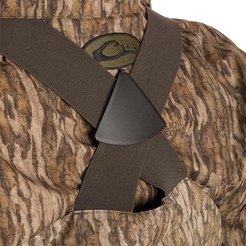 Close-up of the Women’s Insulated Guardian Elite Vanguard Breathable Waders, showing camouflage pattern, reinforced seams, and front cargo pouch.