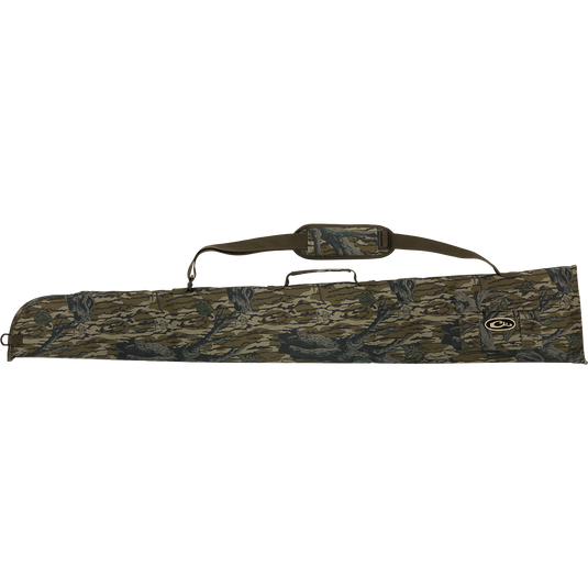 A side-opening gun case with a camouflage design, adjustable strap, and outer accessory pocket for choke tubes.