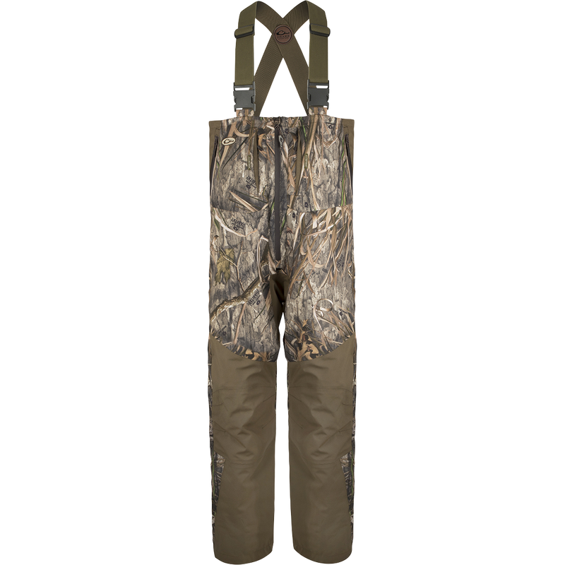 Guardian Flex™ G3 Flex™ Bib with BMZ System Liner: Camouflage overalls with adjustable suspenders and removable insulation panels for customizable warmth.