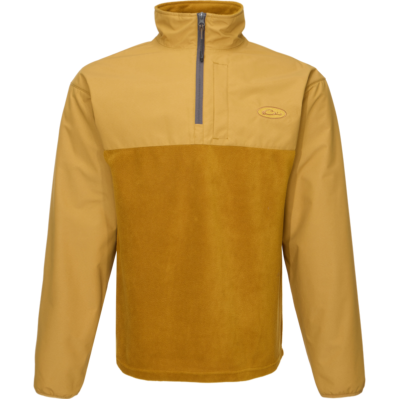 MST Quarter Zip Refuge Eqwader Jacket featuring a close-up of its innovative zipper, logo detail, and durable fabric, designed for superior comfort in waterfowl hunting.